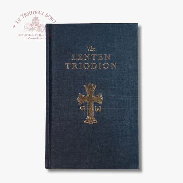 The Lenten Triodion book with a dark navy blue textured cover and gold lettering and cross emblem, shown on a light gray background with a Troupeau Benit watermark in the upper left.